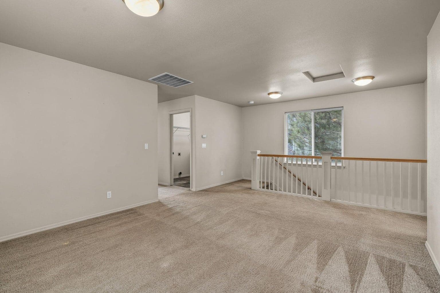 Alternate view of the spacious loft with natural light from large windows.