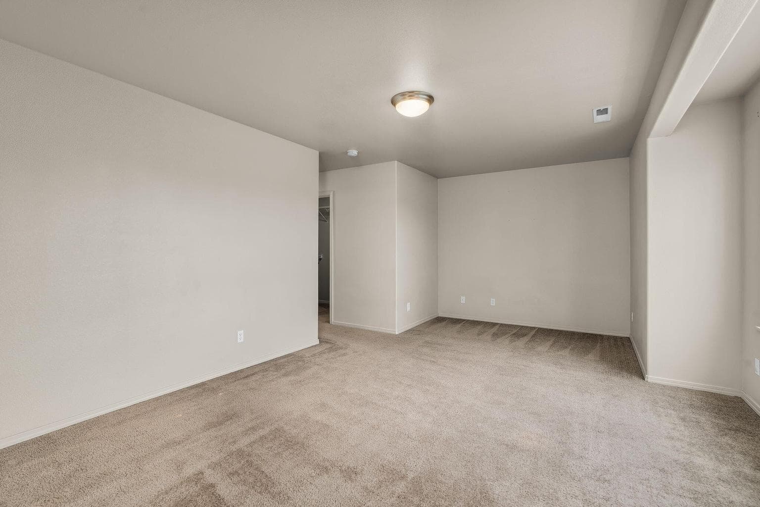 Primary bedroom serving natural sunlight.