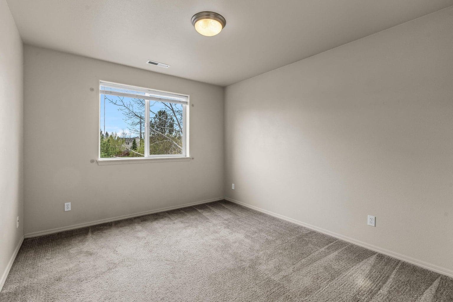 Another view of the second bedroom featuring well-sized window.