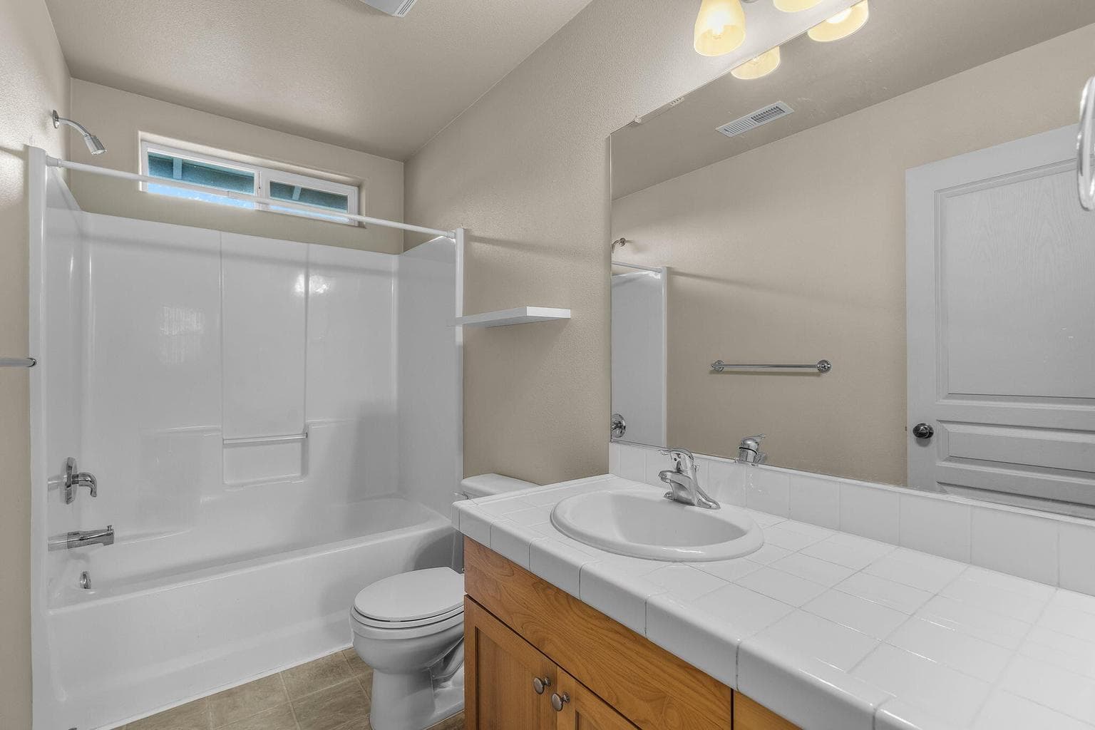 The second full guest bathroom with a shower-tub combination.