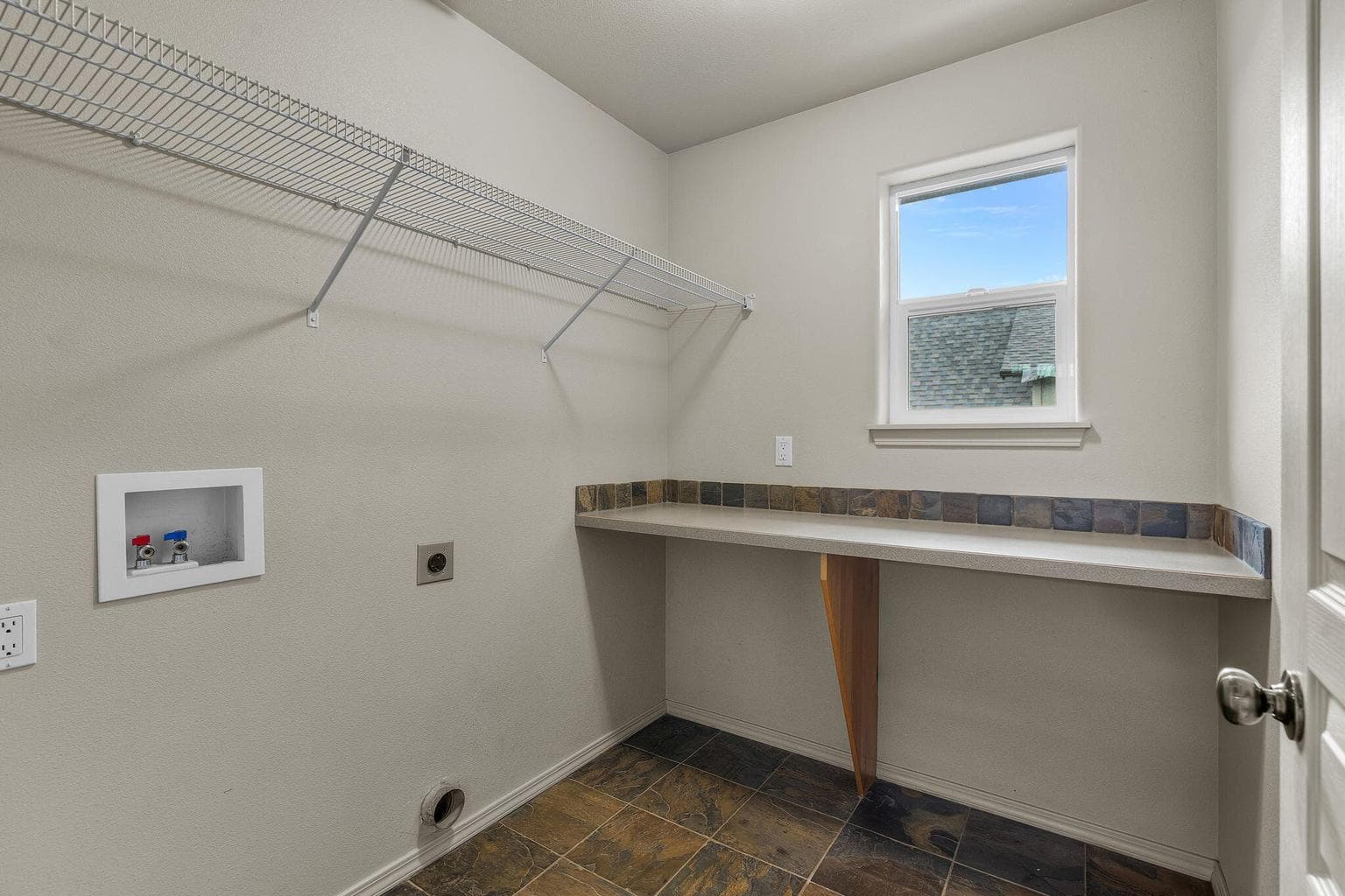 Laundry room area with washer and dryer hookups.