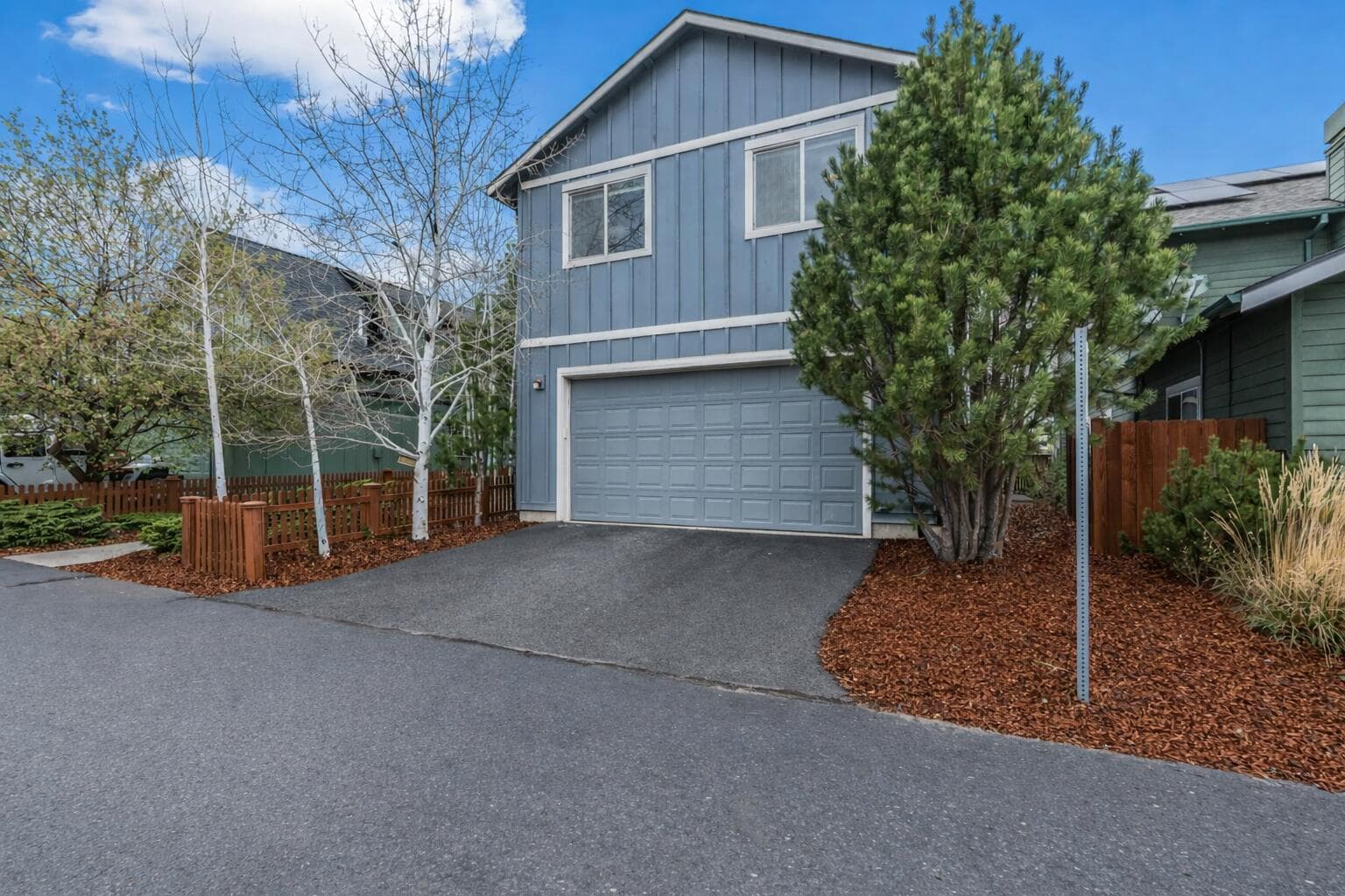 View of the rear alley access leading to the attached double-car garage.