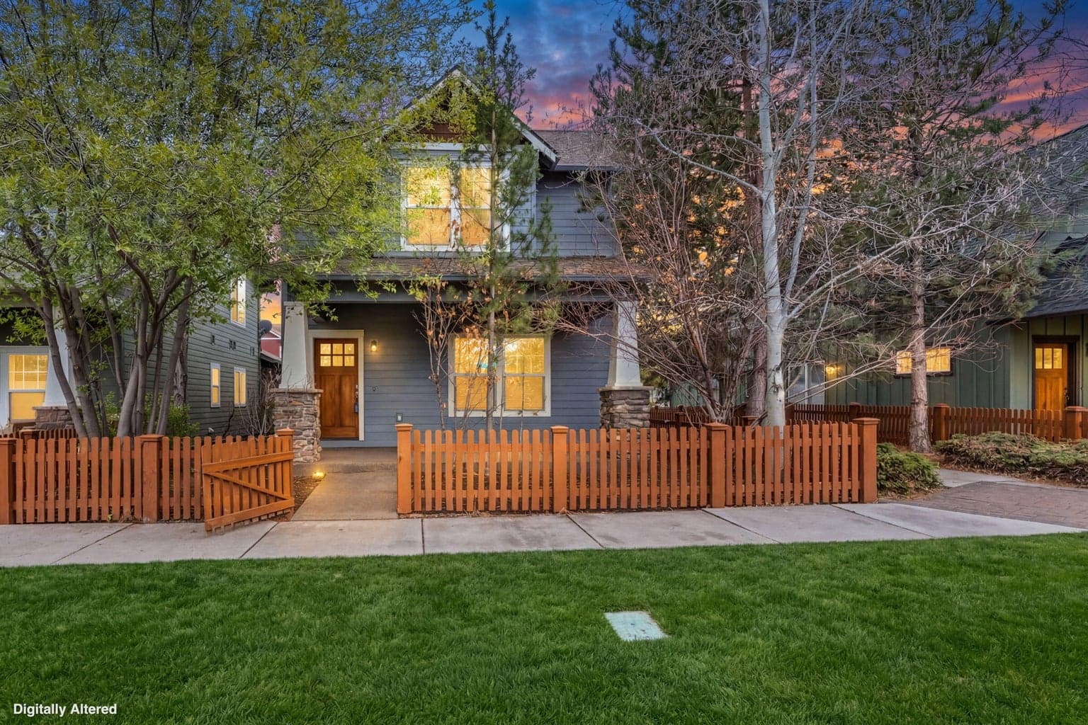 Front exterior of the craftsman-style home in a sunset setting.