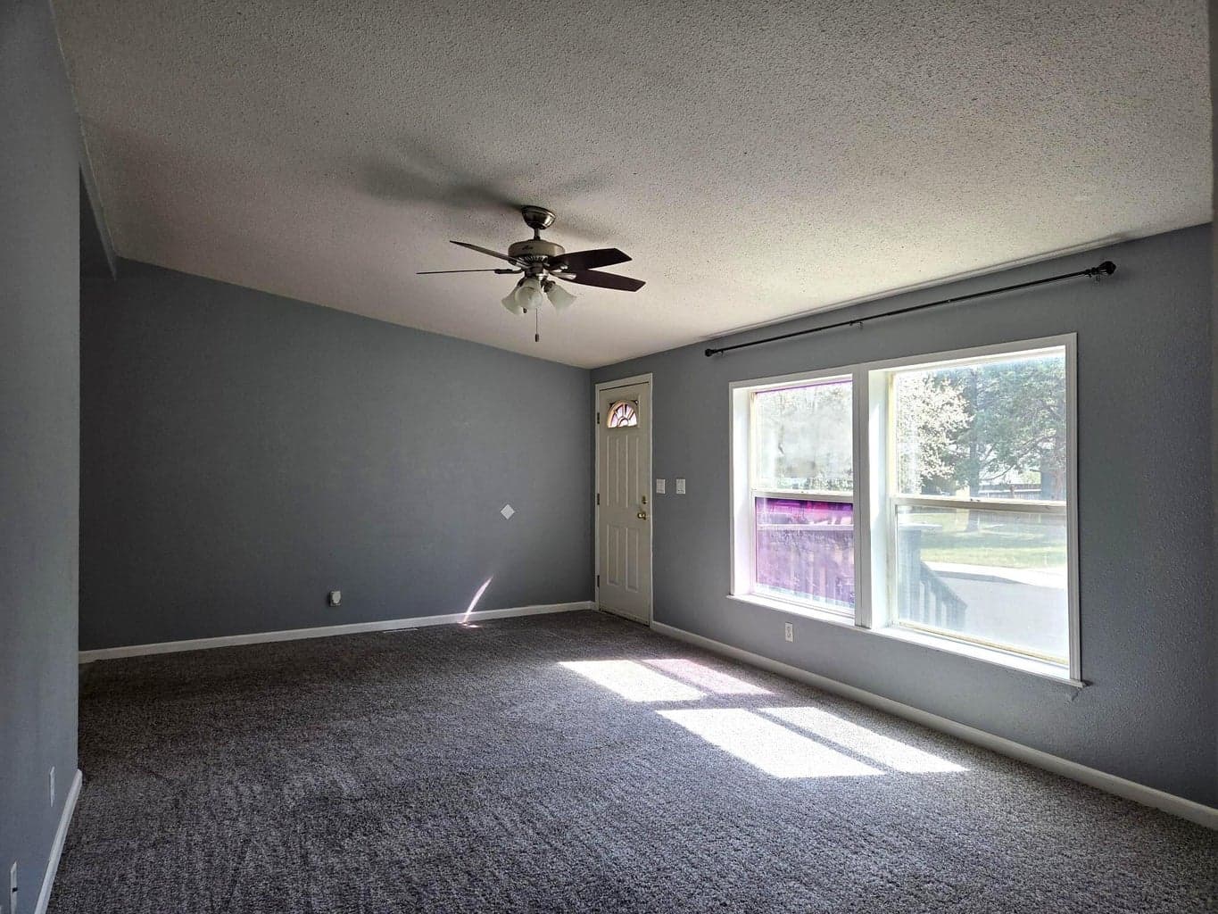 Comfortable living room with large windows and vaulted ceilings