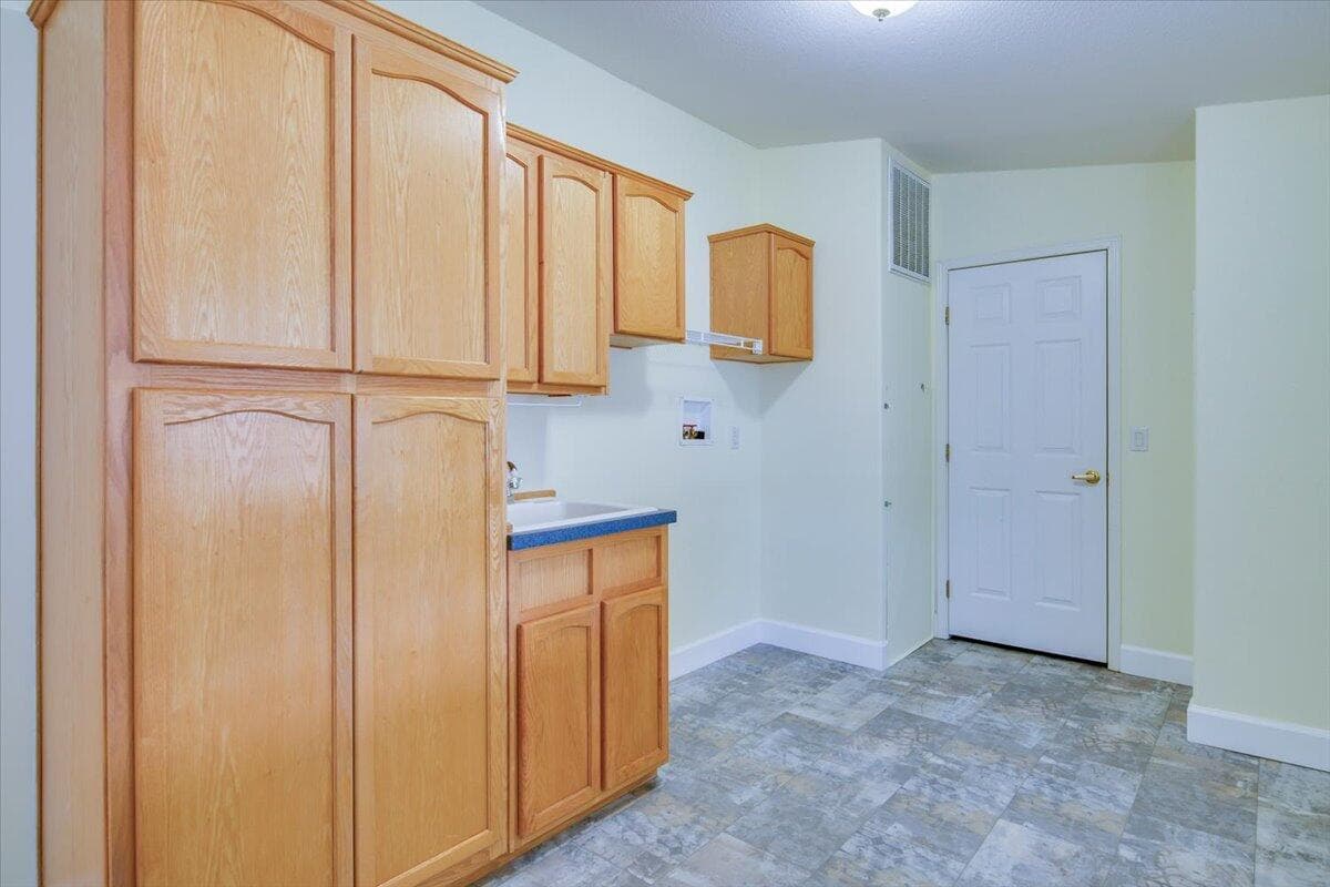 Laundry room with new flooring and storage closet,
