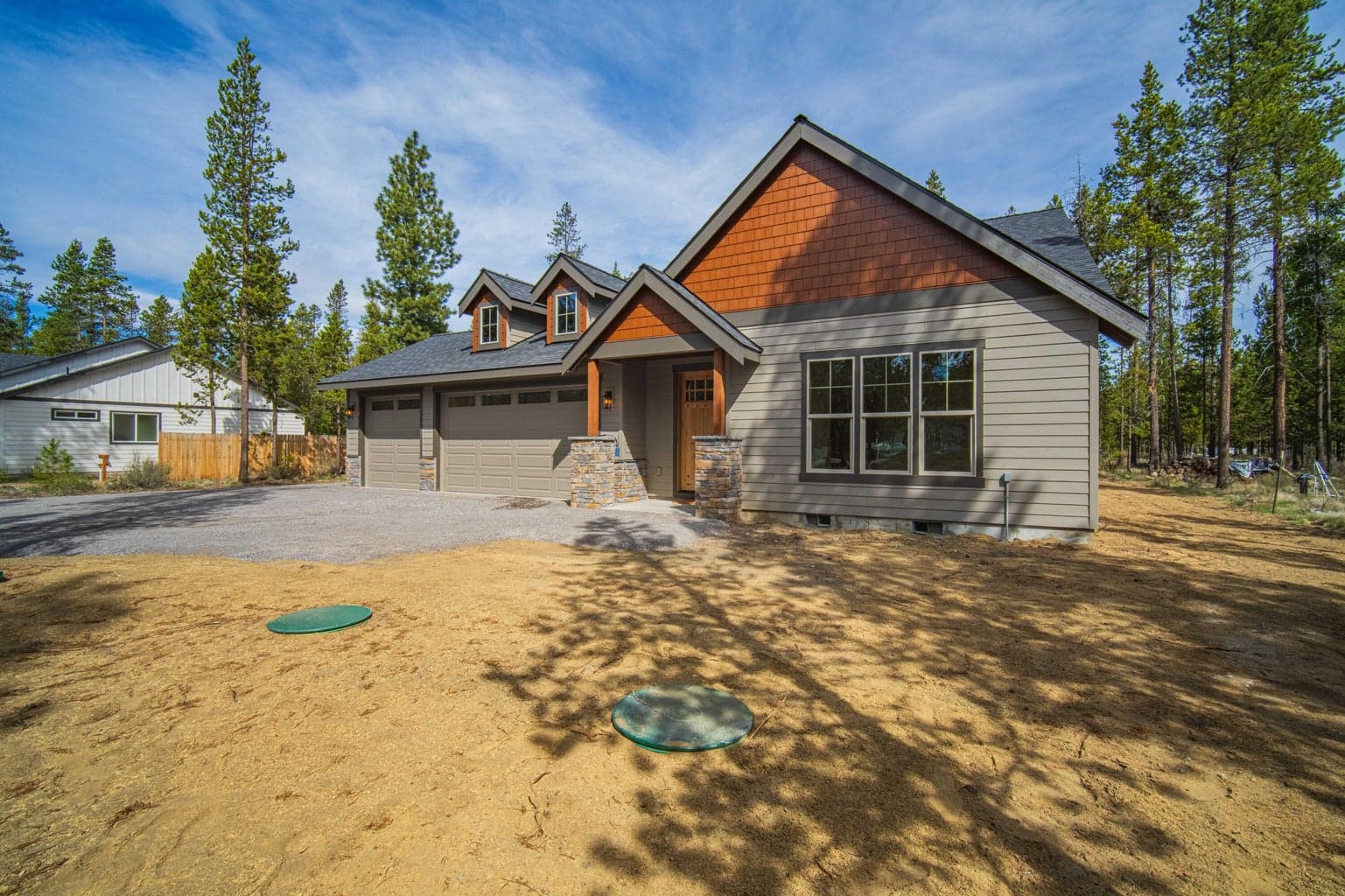 Attractive front elevation showcasing quality craftsmanship, clean design, and the peaceful pine setting of this Covina Road home.