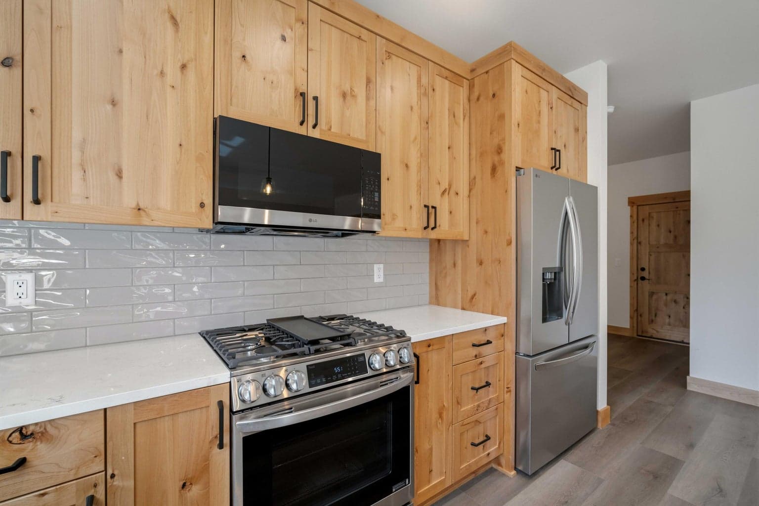 Well-appointed kitchen featuring a propane range, full-height cabinetry, and classic finishes that blend function with mountain-inspired style.