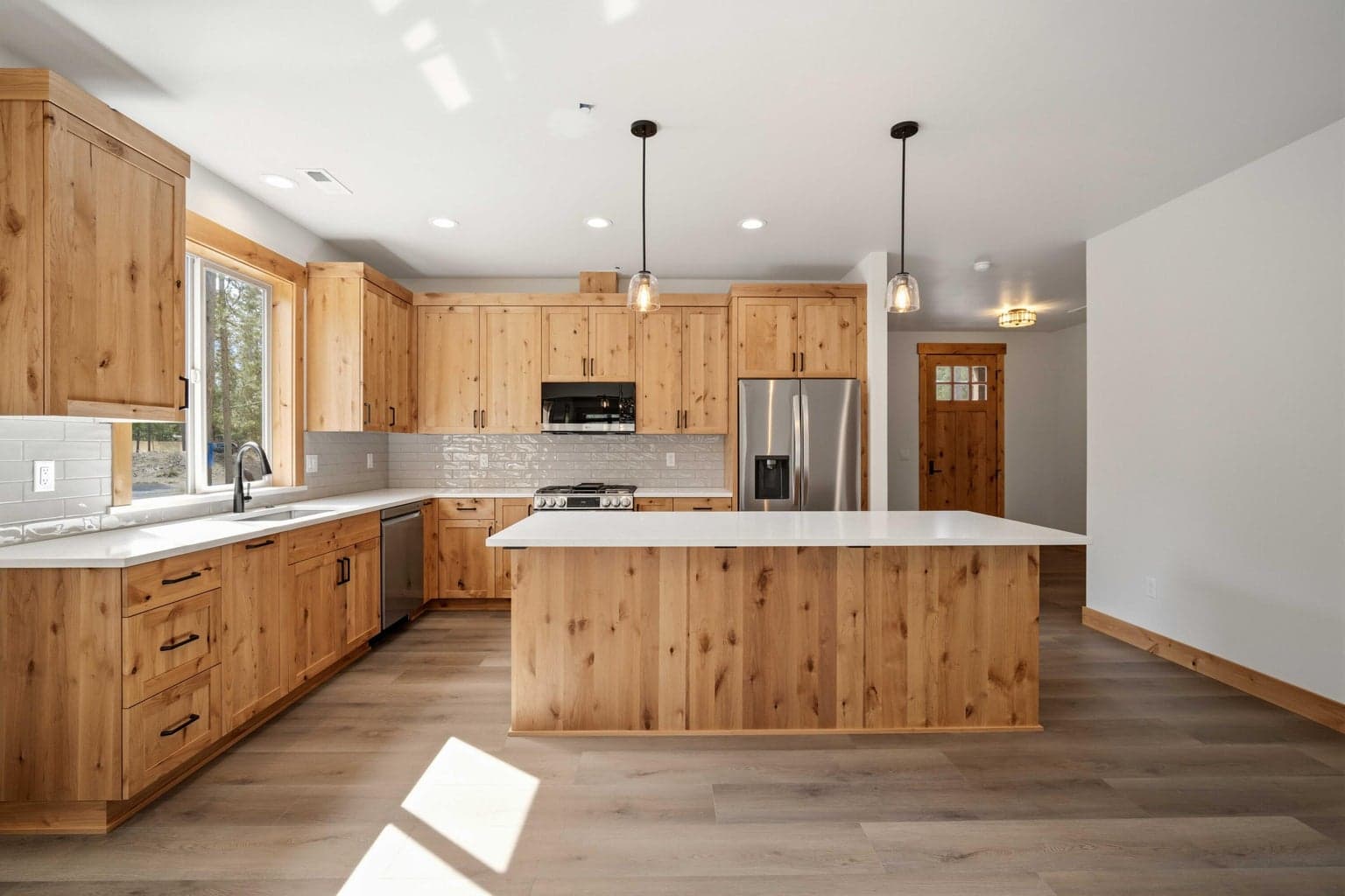 Spacious island kitchen offers abundant prep space, quality finishes, and an easy flow into the main living areas.