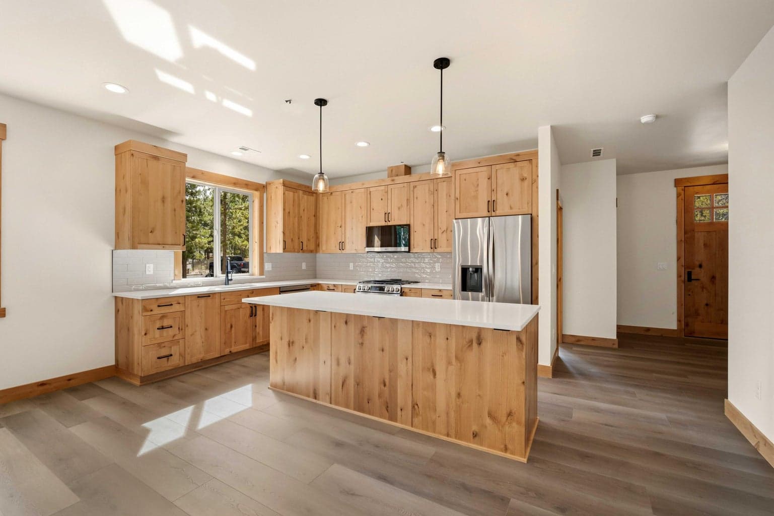 Bright and welcoming kitchen with a large center island, stainless appliances, and timeless finishes inspired by high desert living.