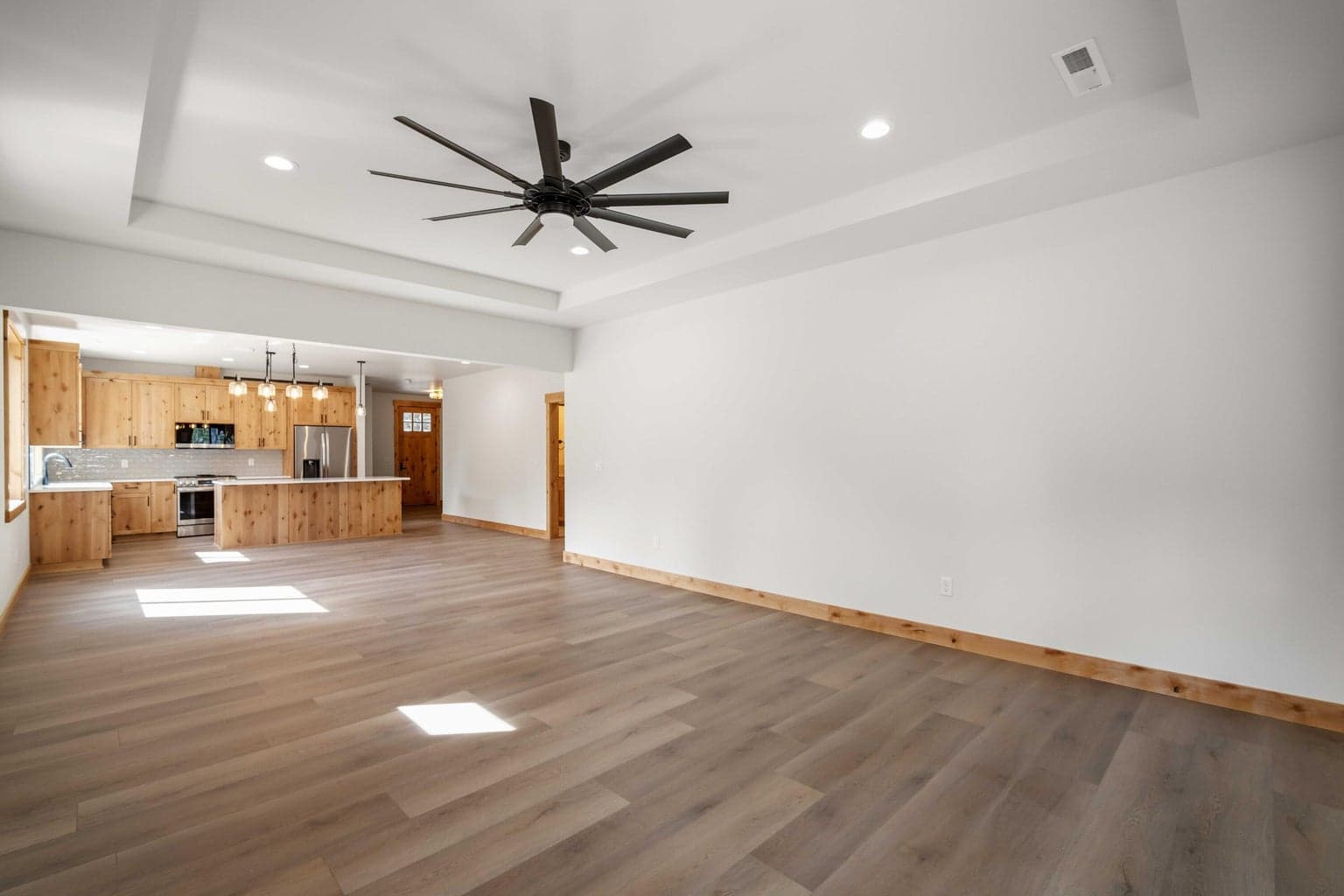 Light-filled great room showcases clean lines, warm wood accents, and a layout that feels both open and inviting.