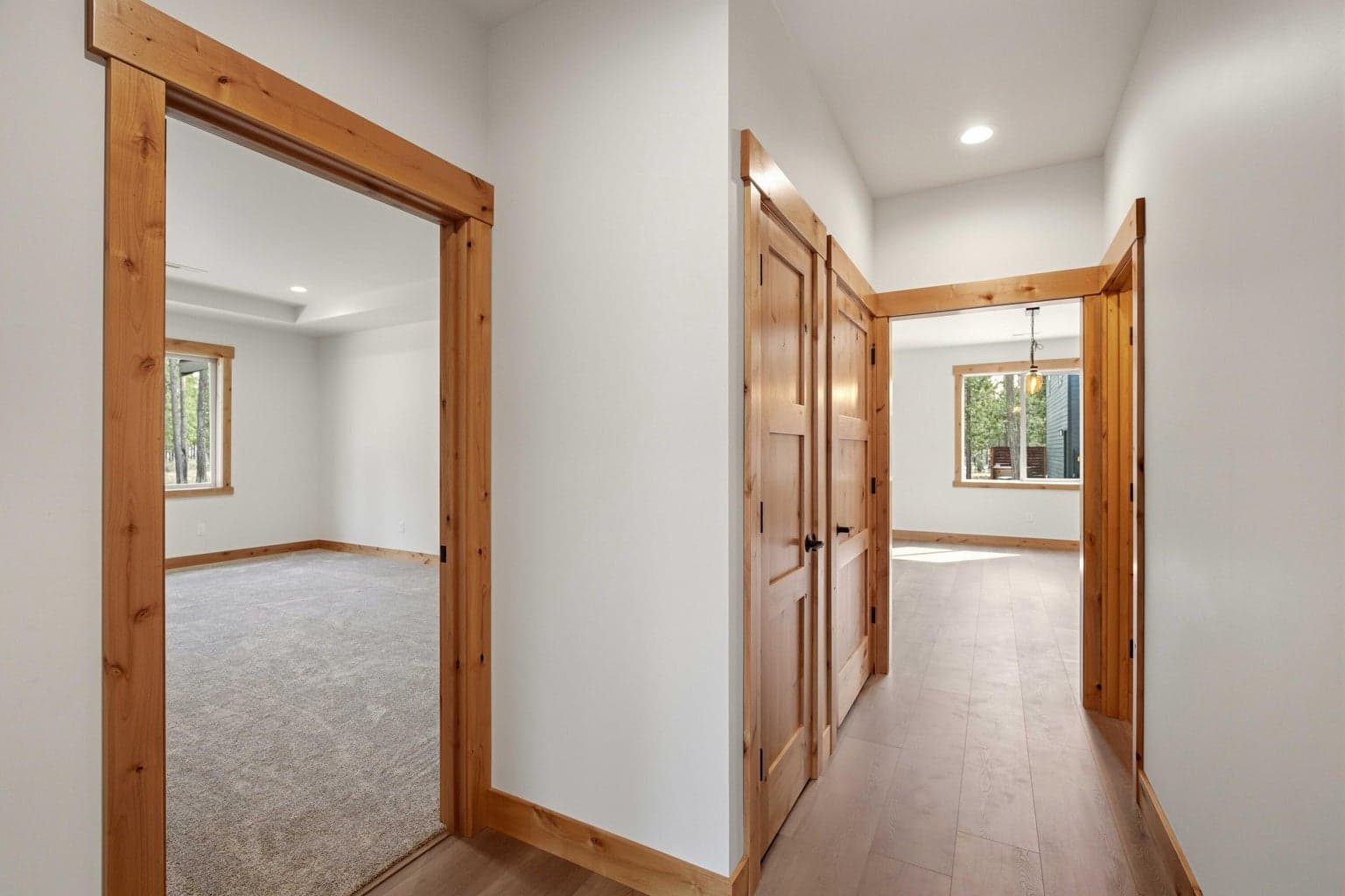 Thoughtful bedroom wing layout with warm wood trim and durable flooring, offering a functional flow through the home.