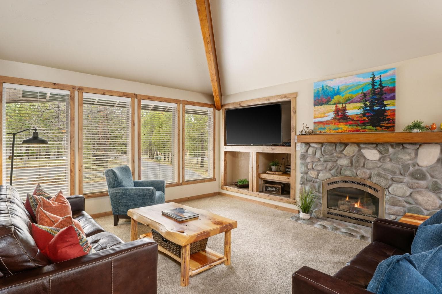 Great room with rock fireplace and vaulted ceilings