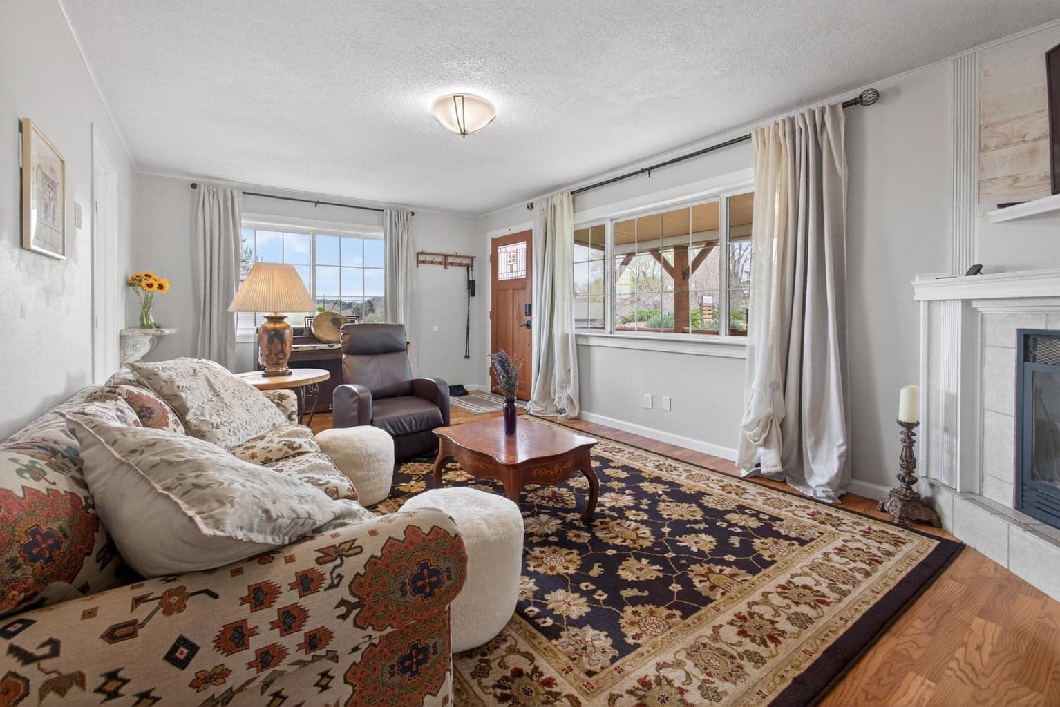 Large living room features gas fireplace. Marble shelf is excluded from sale.