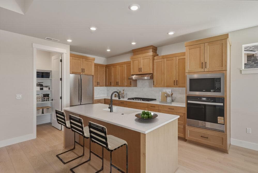 Kitchen with virtual staging. Upgrades include solid shelving and kitchen 5-piece st (drop in stove instead of stove/range).