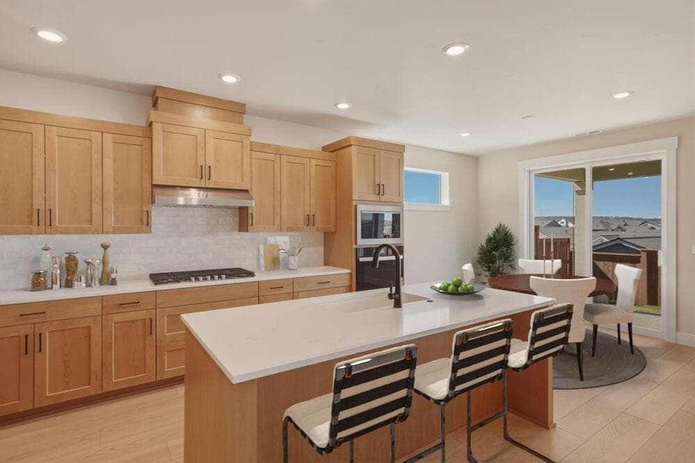 Kitchen to dining with virtual staging. Dining area that leads to the large covered rear patio.