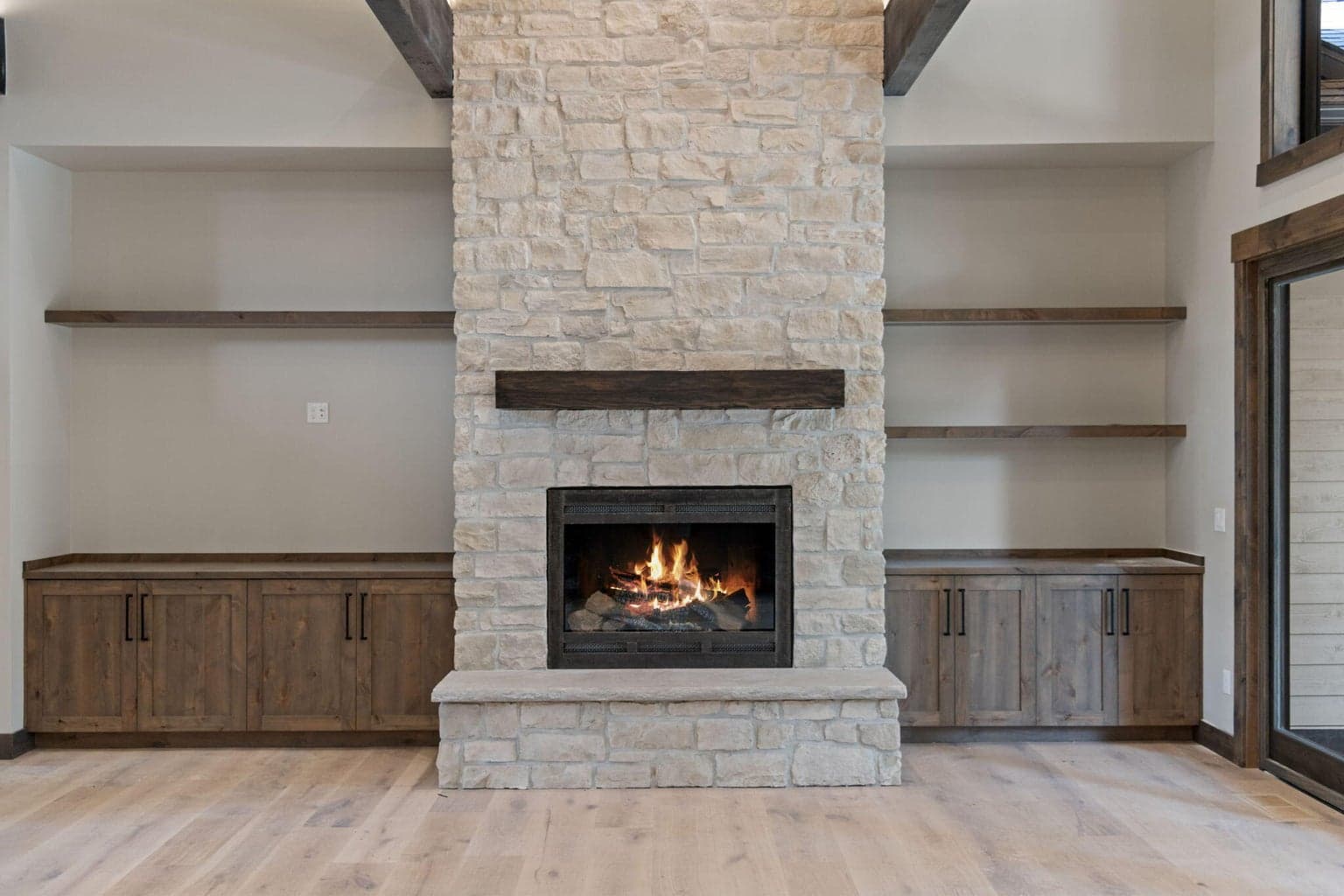 Stacked stone floor to ceiling Heat n Glo gas fireplace...