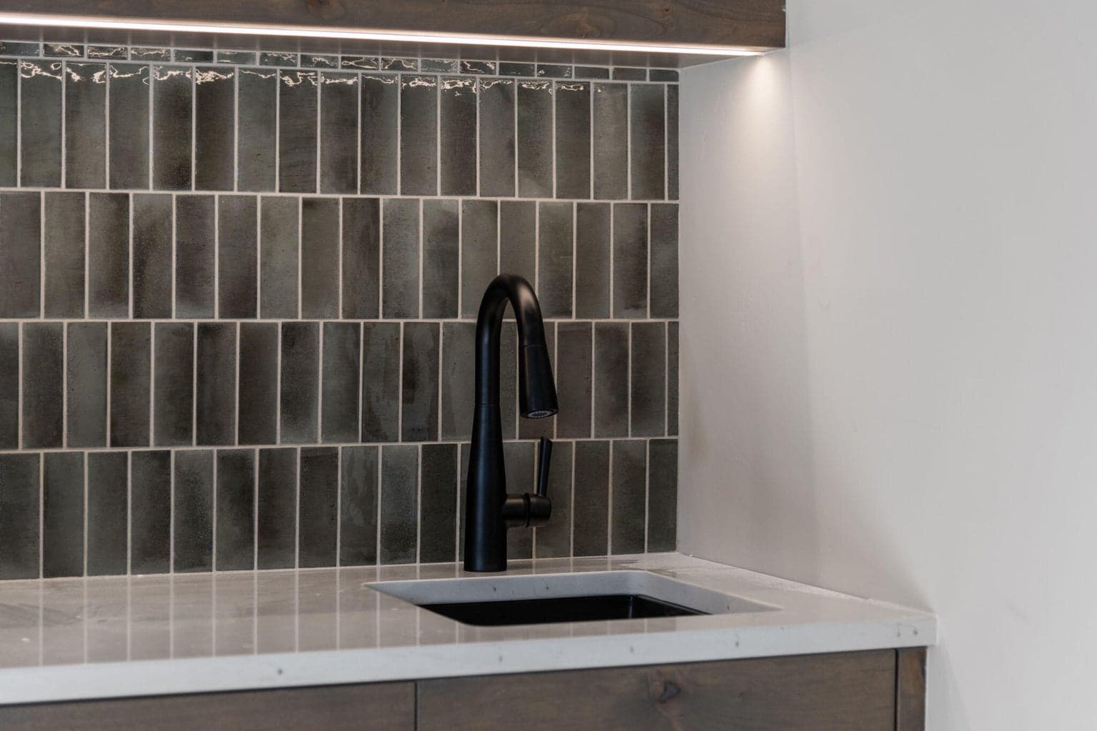 Custom tilework in bonus room wet bar upstairs