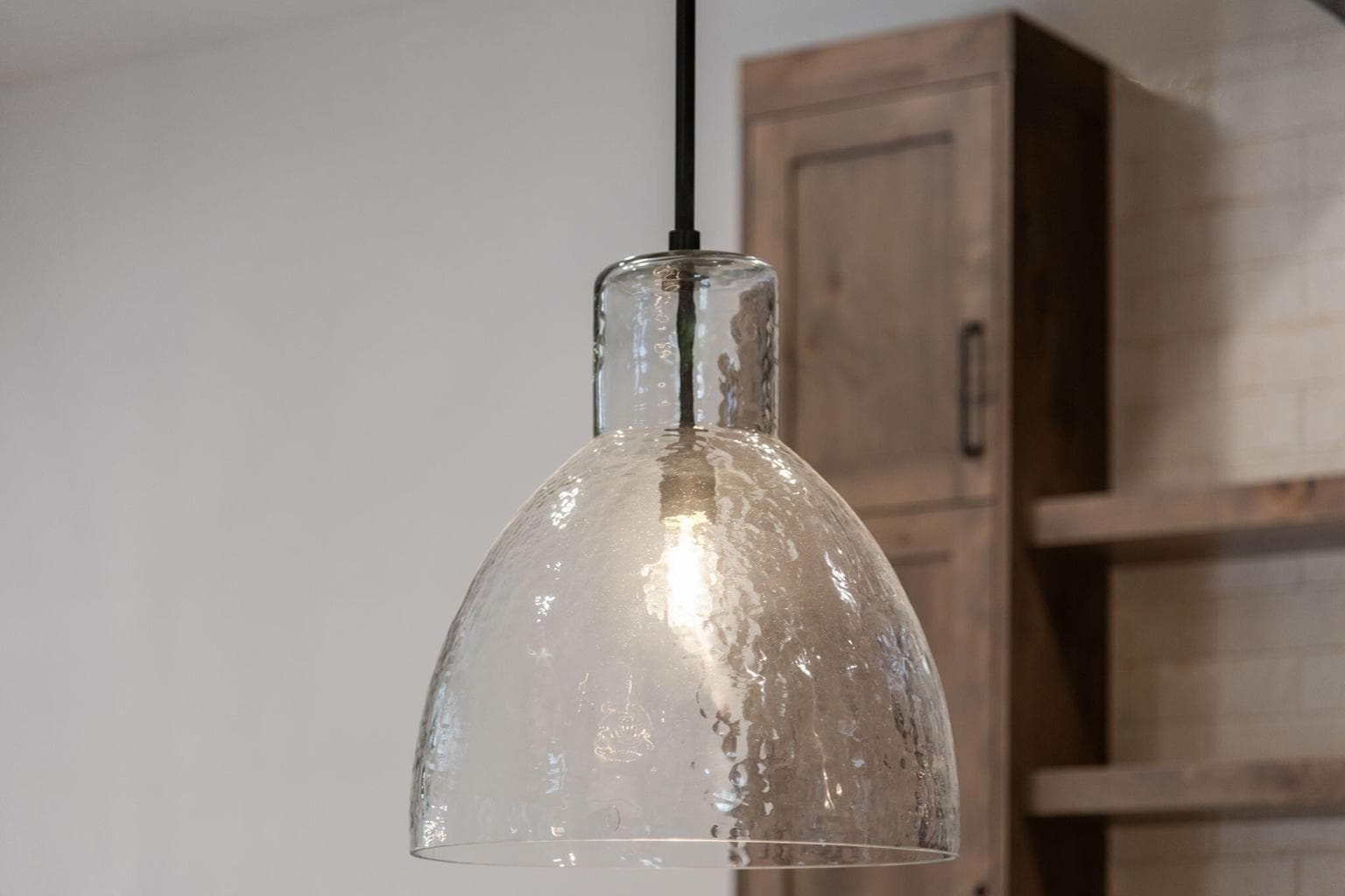 Stunning light fixtures from Restoration Hardware, West Elm and Pottery Barn through the home including over the kitchen island