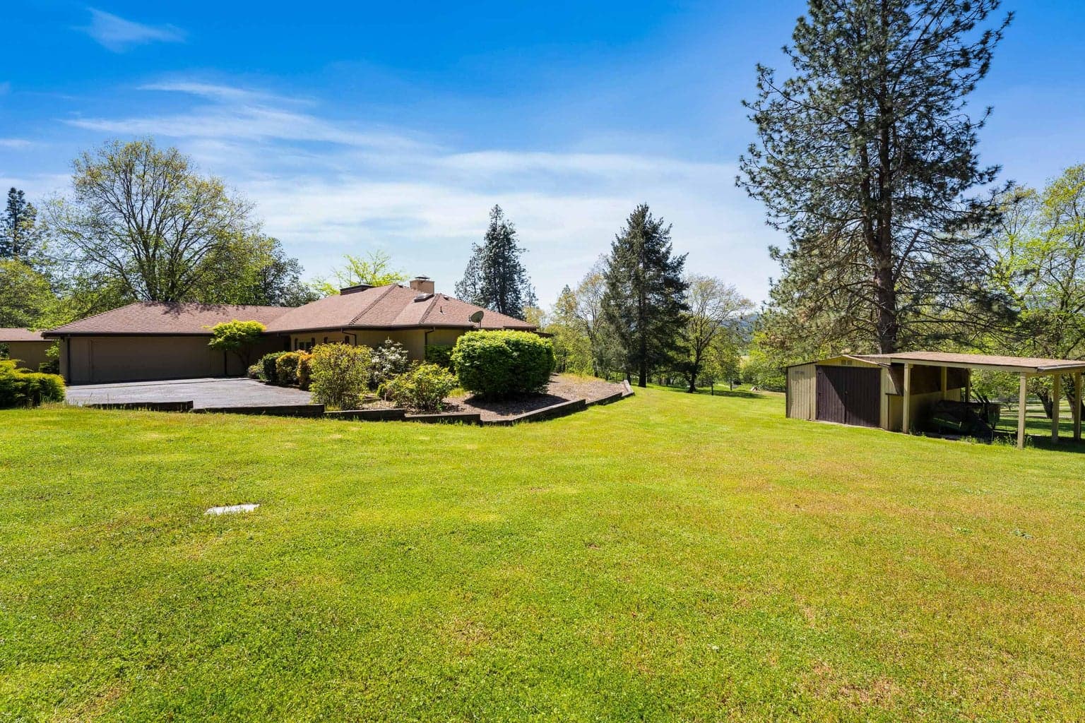 Spacious golf course park-like lawns and open skies for lushious gardens surround this home.