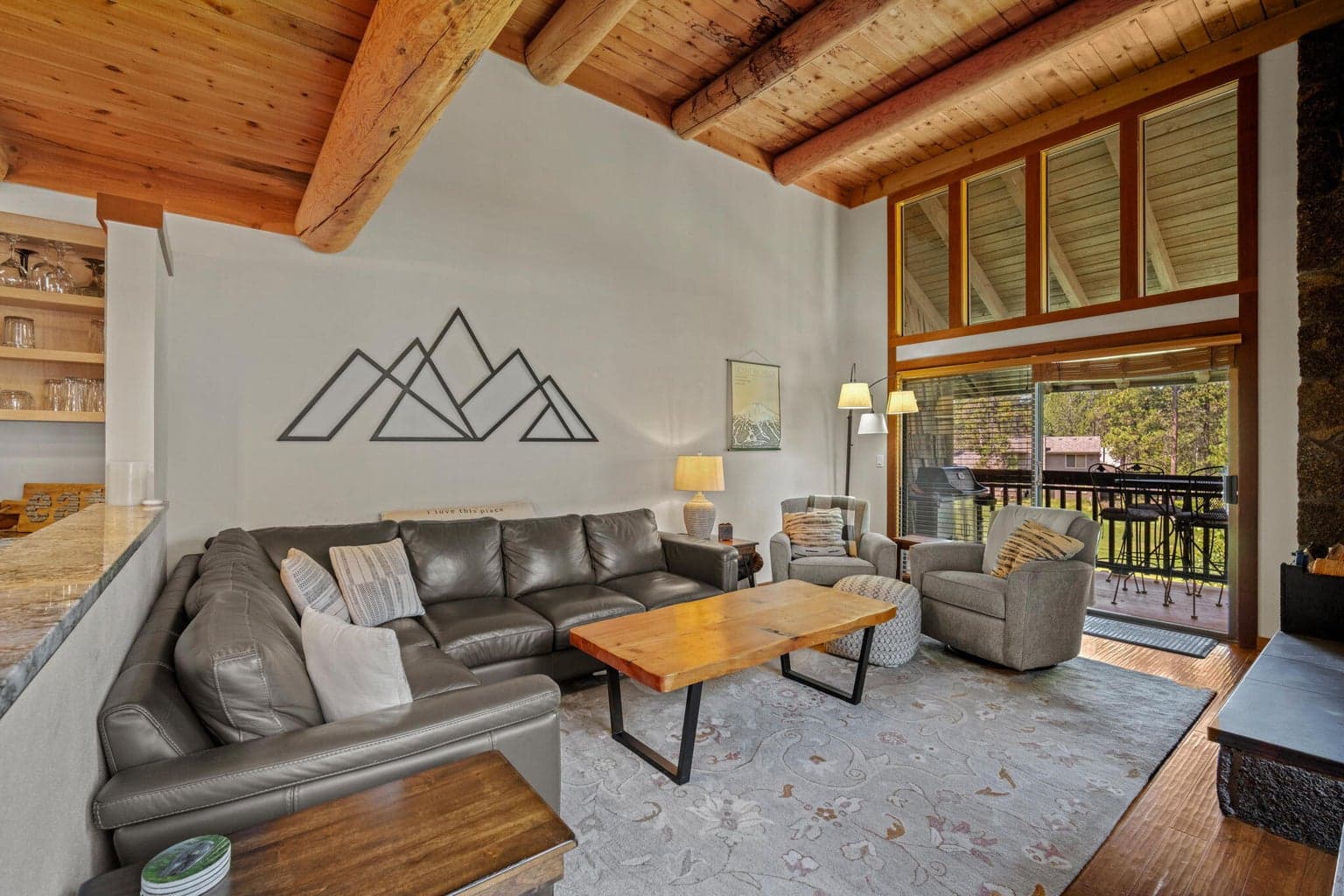 Living room with wood ceilings and lots of windows