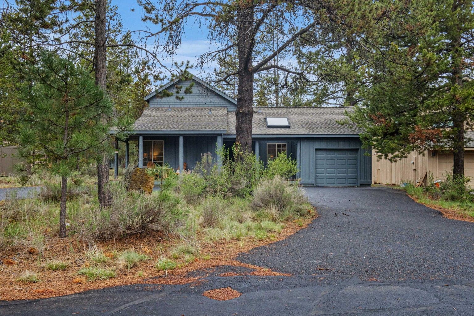 Enjoy the curb appeal of a half circle, asphalt driveway