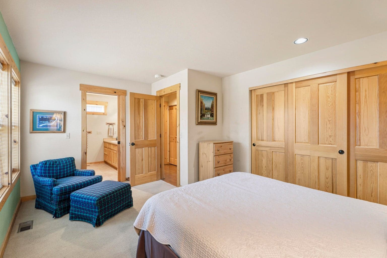 Main floor bedroom with door to attached bathroom