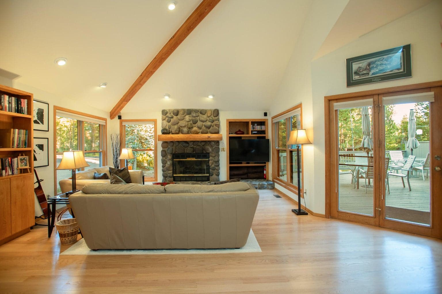 Hardwood flooring in the living areas and a beautiful river rock gas fireplace