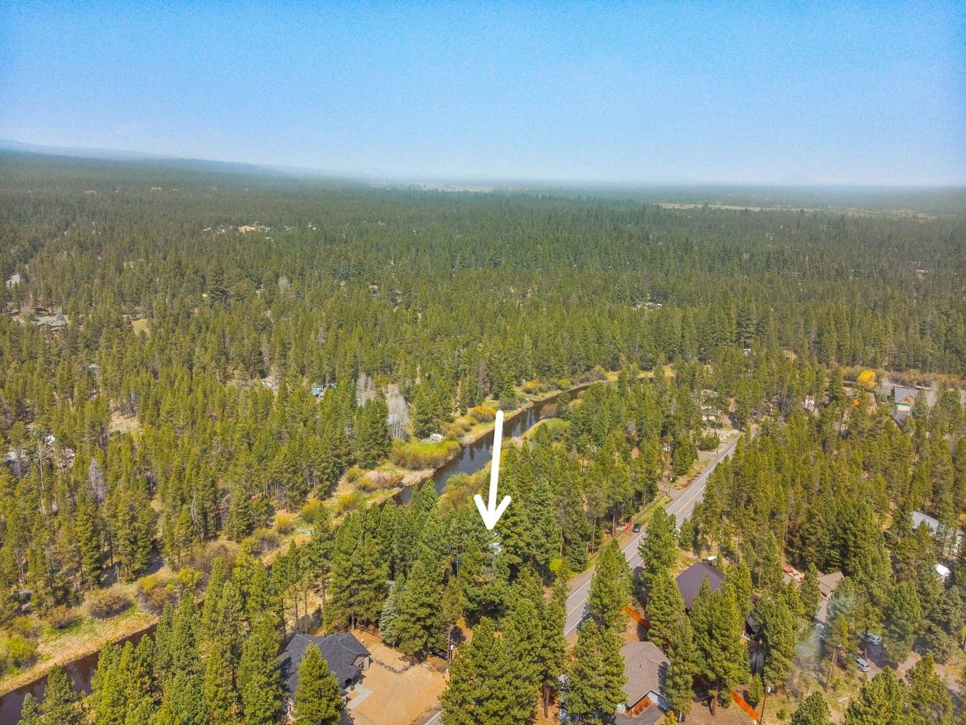 Sweeping aerial of the chalet's setting within the iconic Central Oregon pine forest