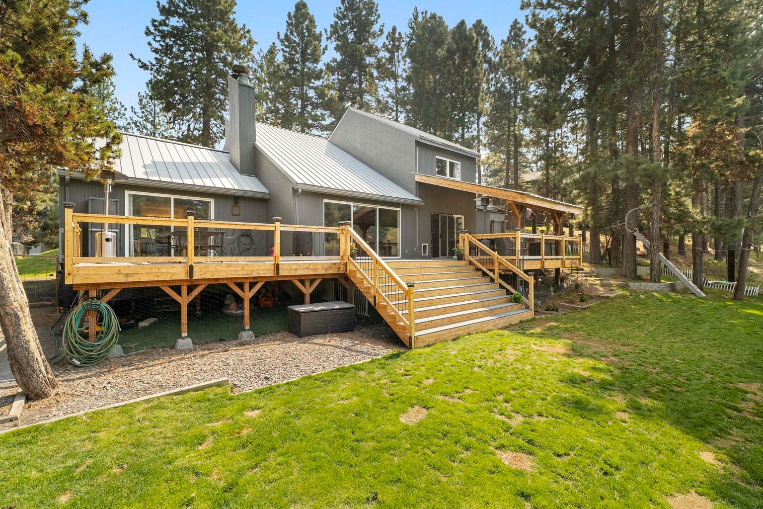 Two-tier deck system cascades down the chalet's rear elevation