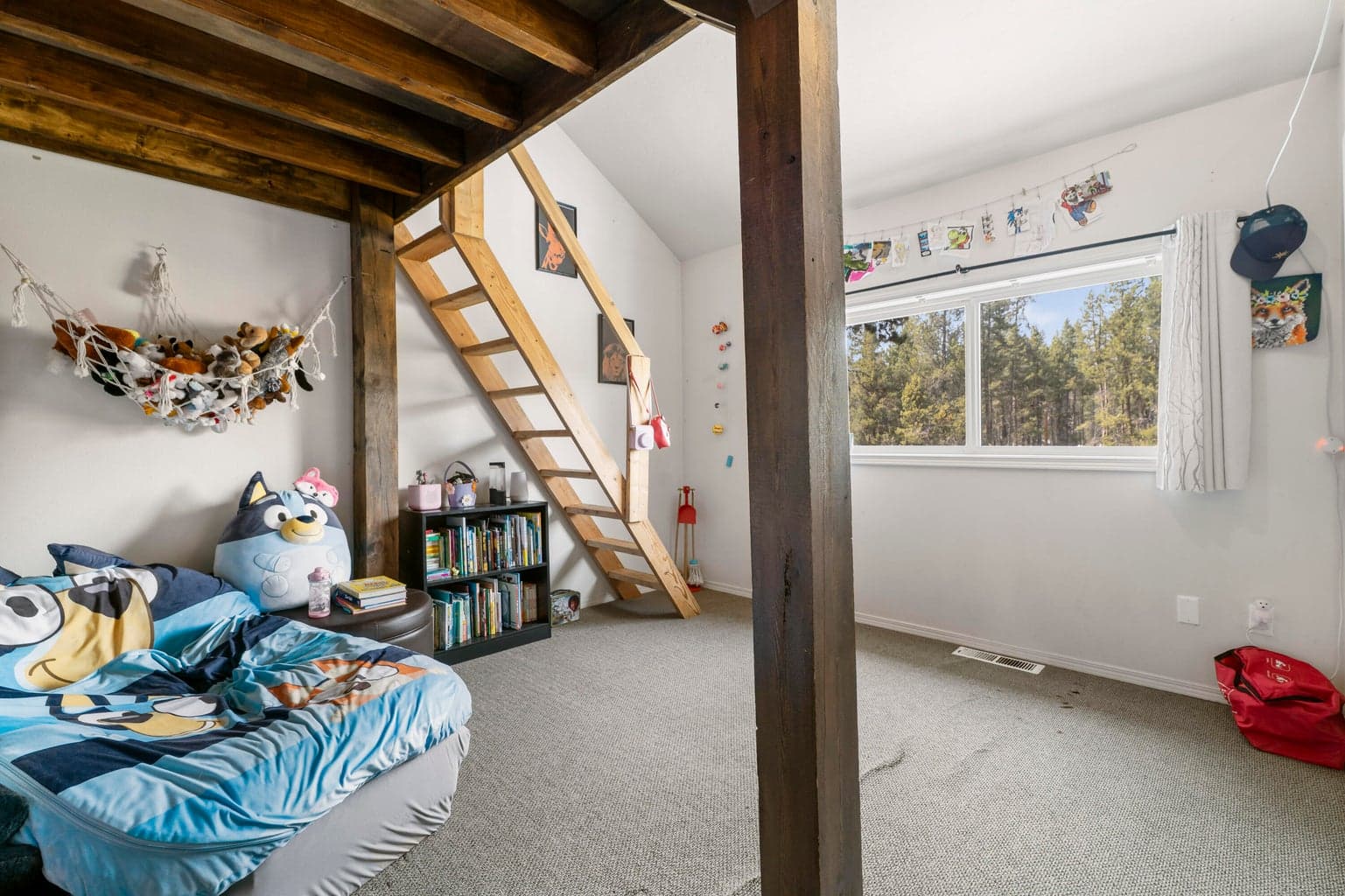 Custom-built timber loft bed with reading nook tucked beneath — every kid's dream