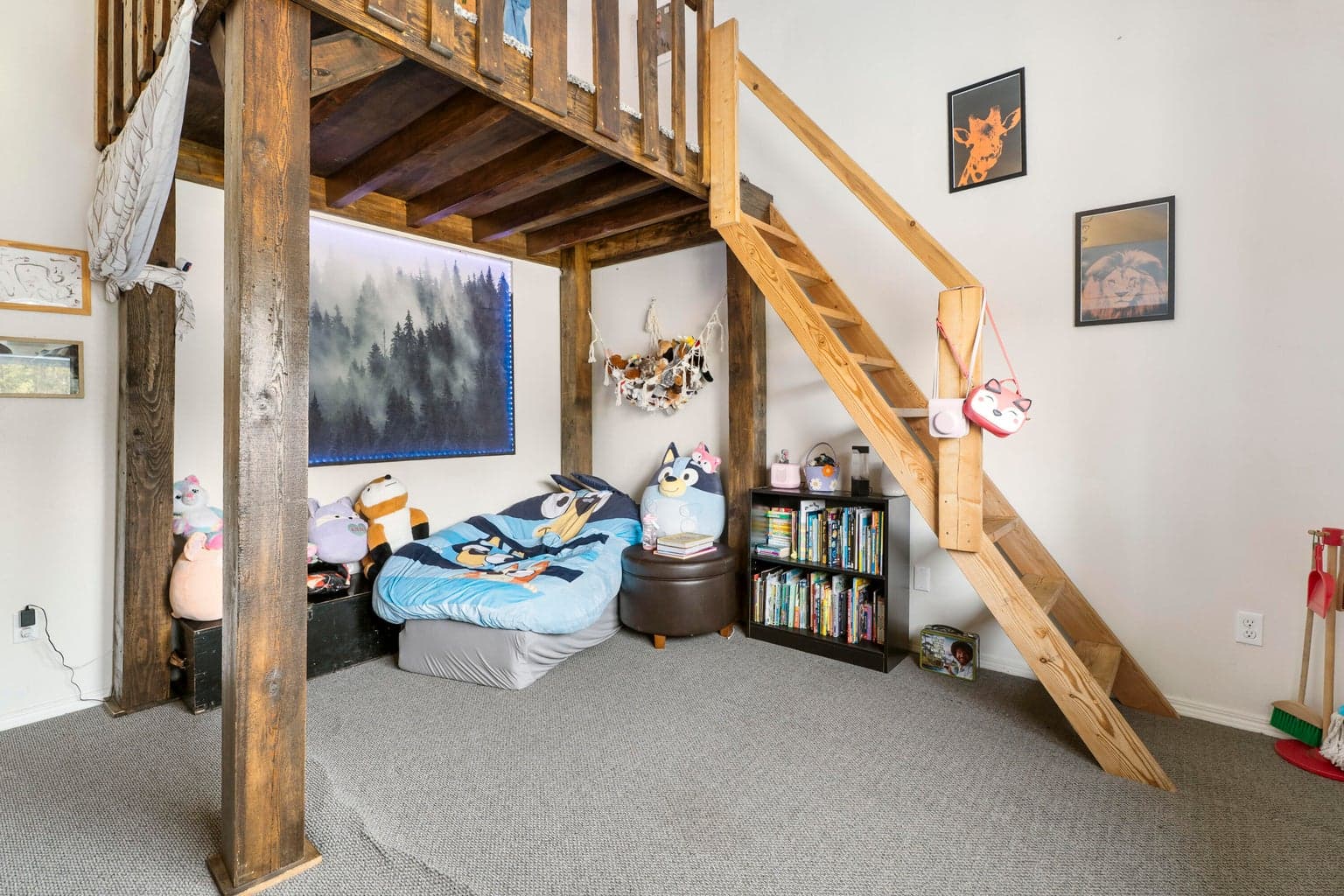 Timber-frame loft turns one room into two — sleep above, play below