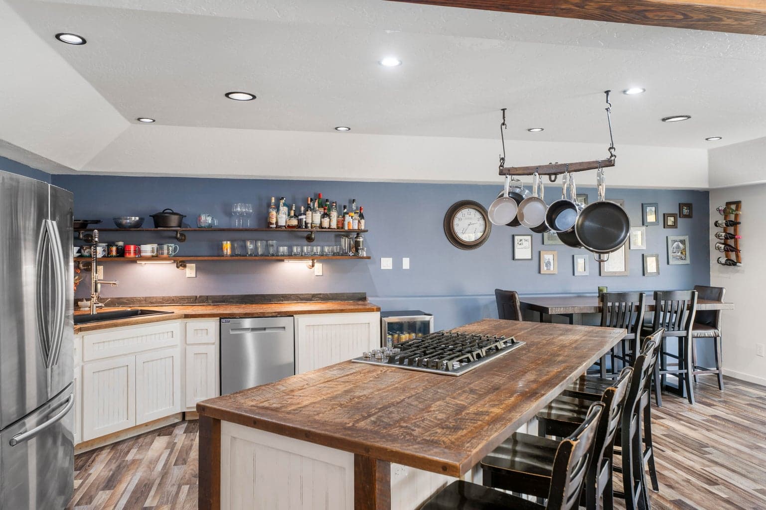 Reclaimed wood island and countertops with gas cooktop, and hanging pot rack
