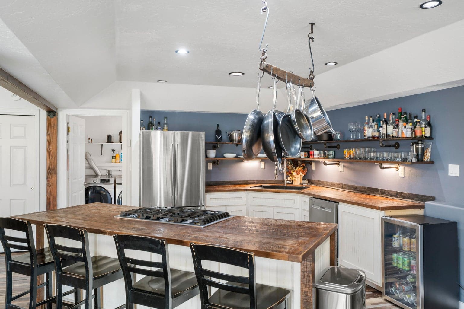 Kitchen pass-through to walk-in laundry and pantry beyond
