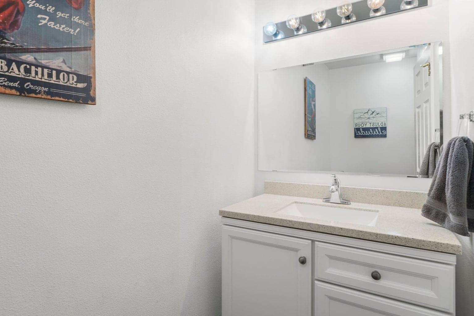 Guest bathroom off the living room with vintage Mt. Bachelor signage and Central Oregon character