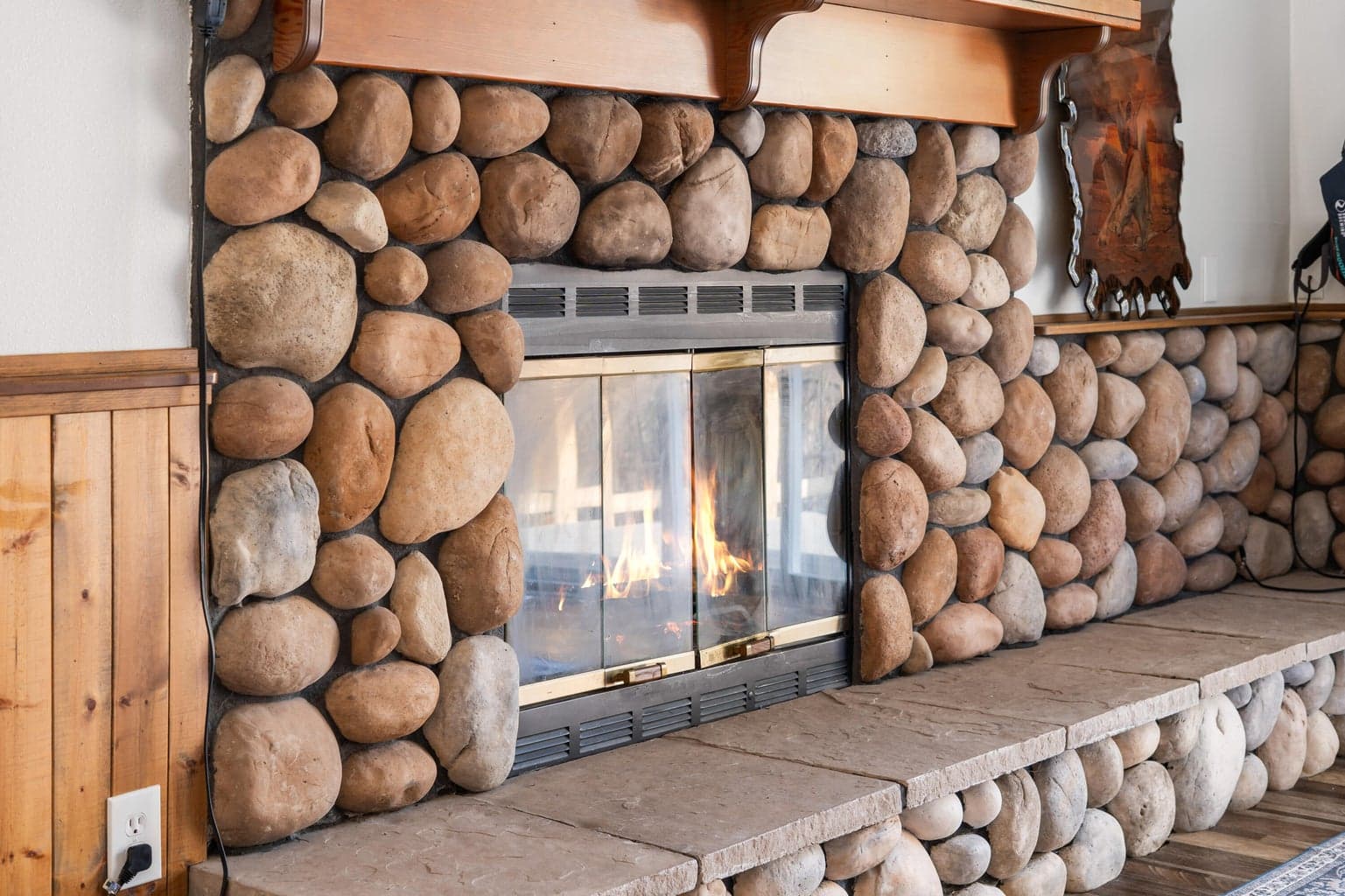 Primary suite's private river-rock fireplace