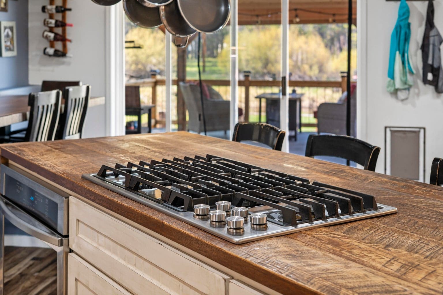 Stainless appliances, open shelving, and entertainer's layout anchor the kitchen