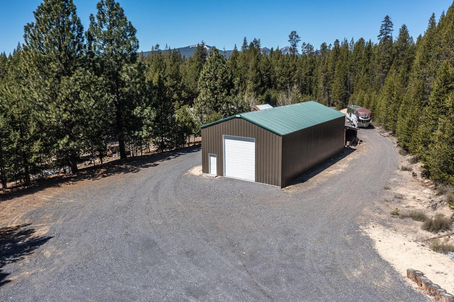 Massive 2,116 SF insulated steel shop with 14' drive-thru doors.