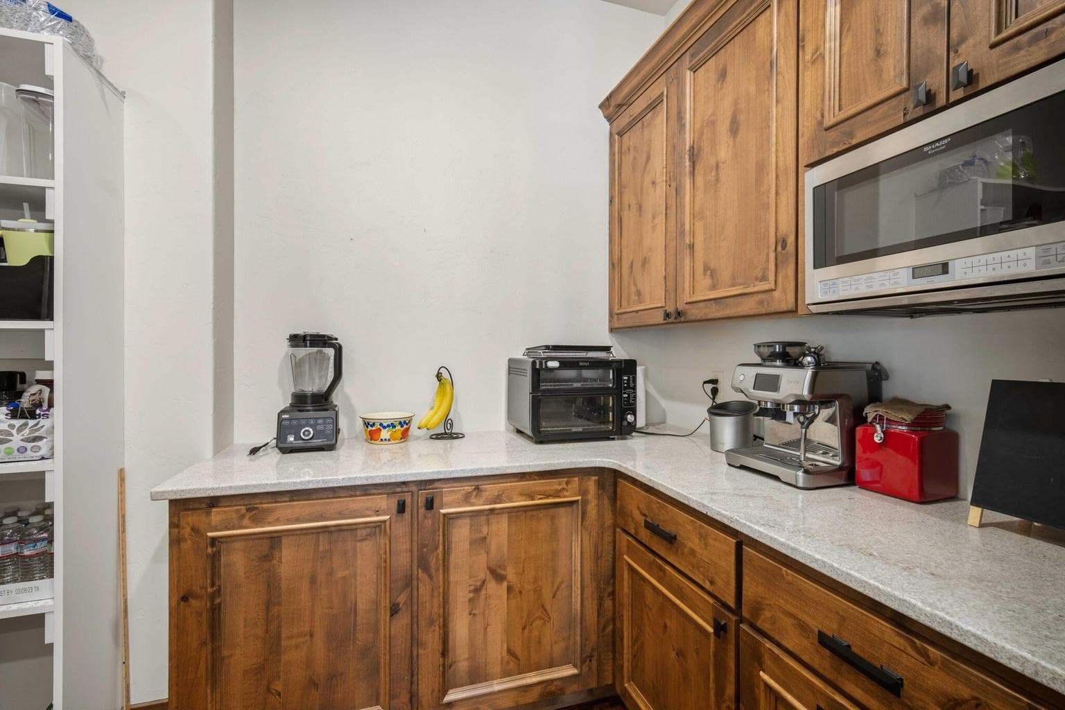 Additional kitchen space that leads to a walk in pantry