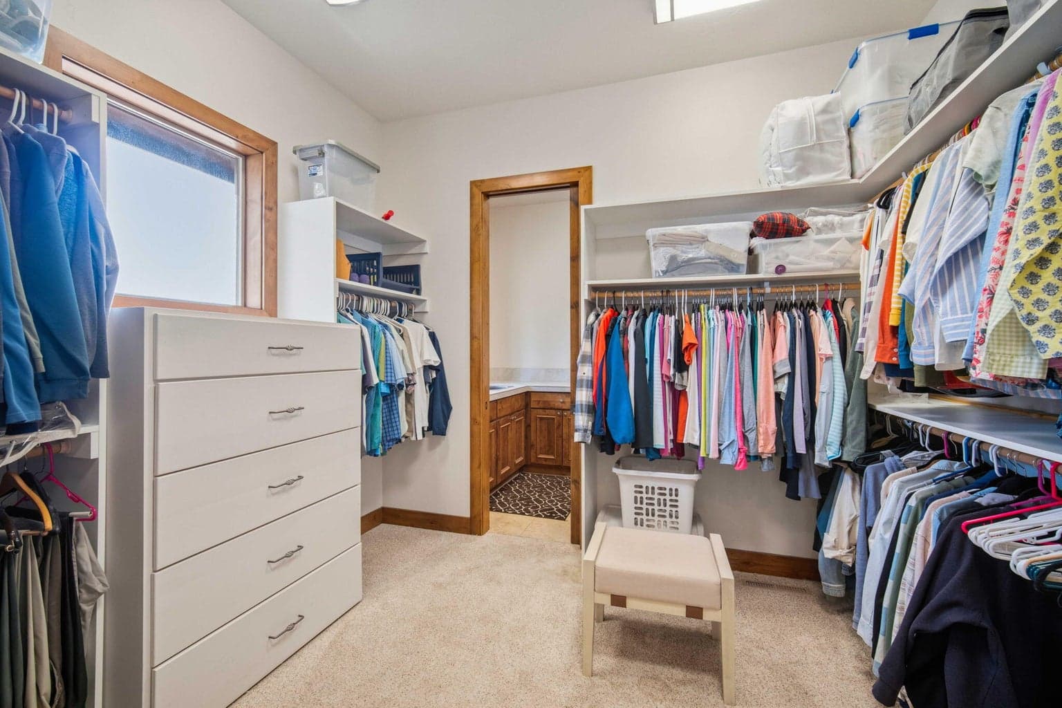 Walk in closet in primary bedroom.