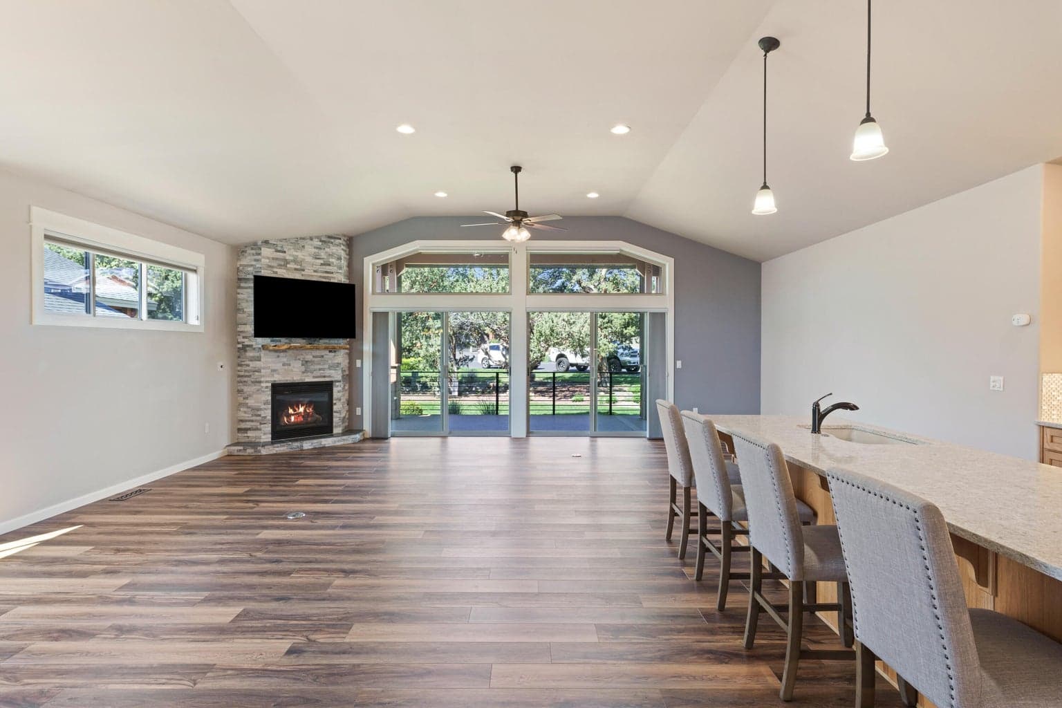 Vaulted ceilings with ceiling fan.