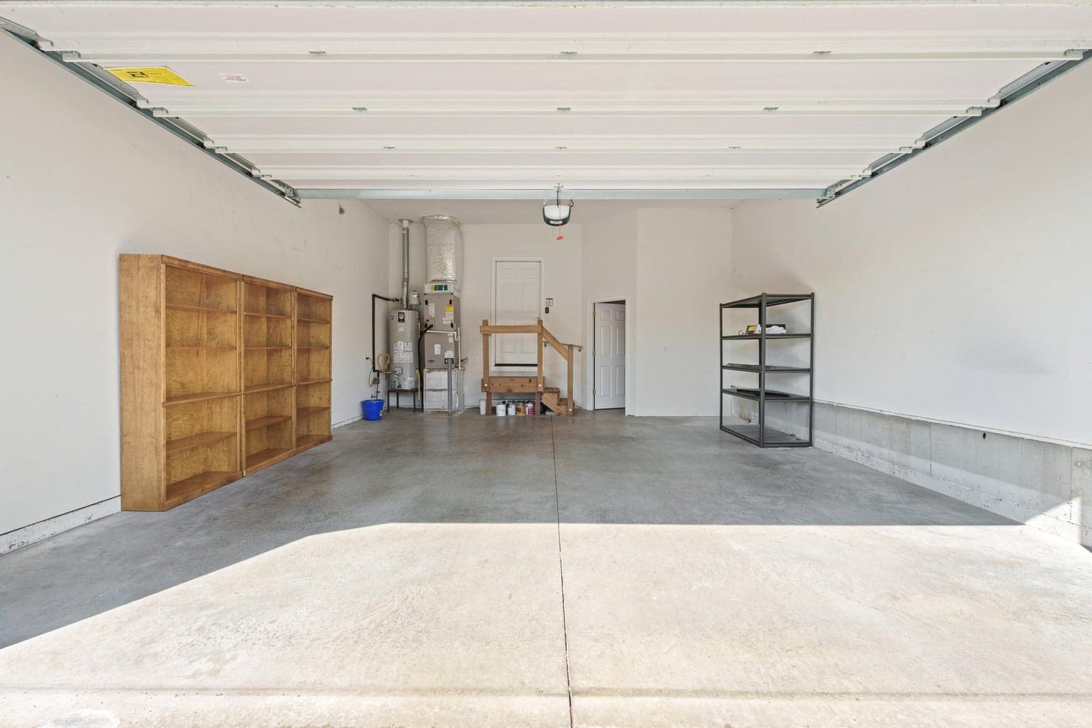 Spacious finished garage with separate storage room.