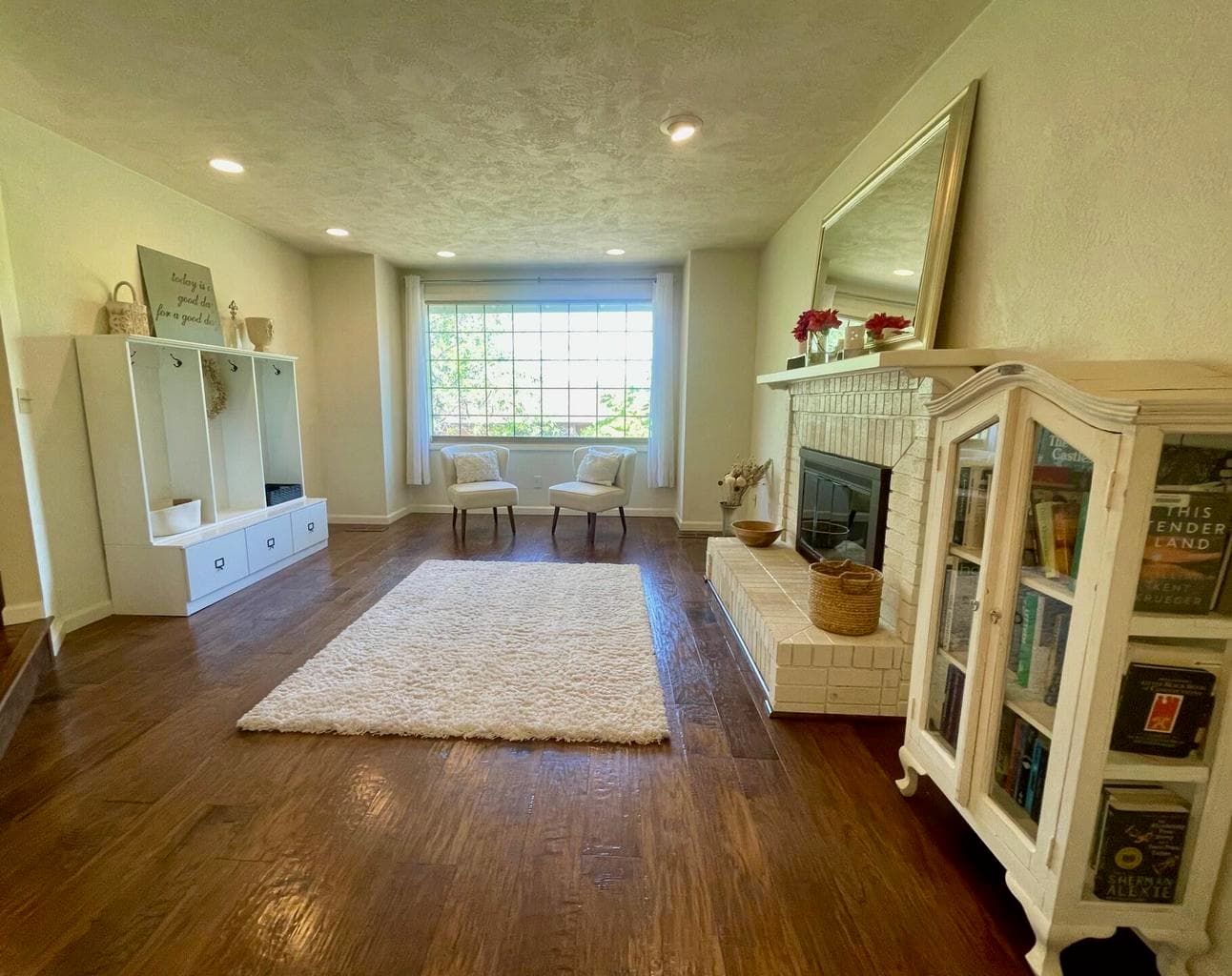 Front living room with wood-burning fireplace.