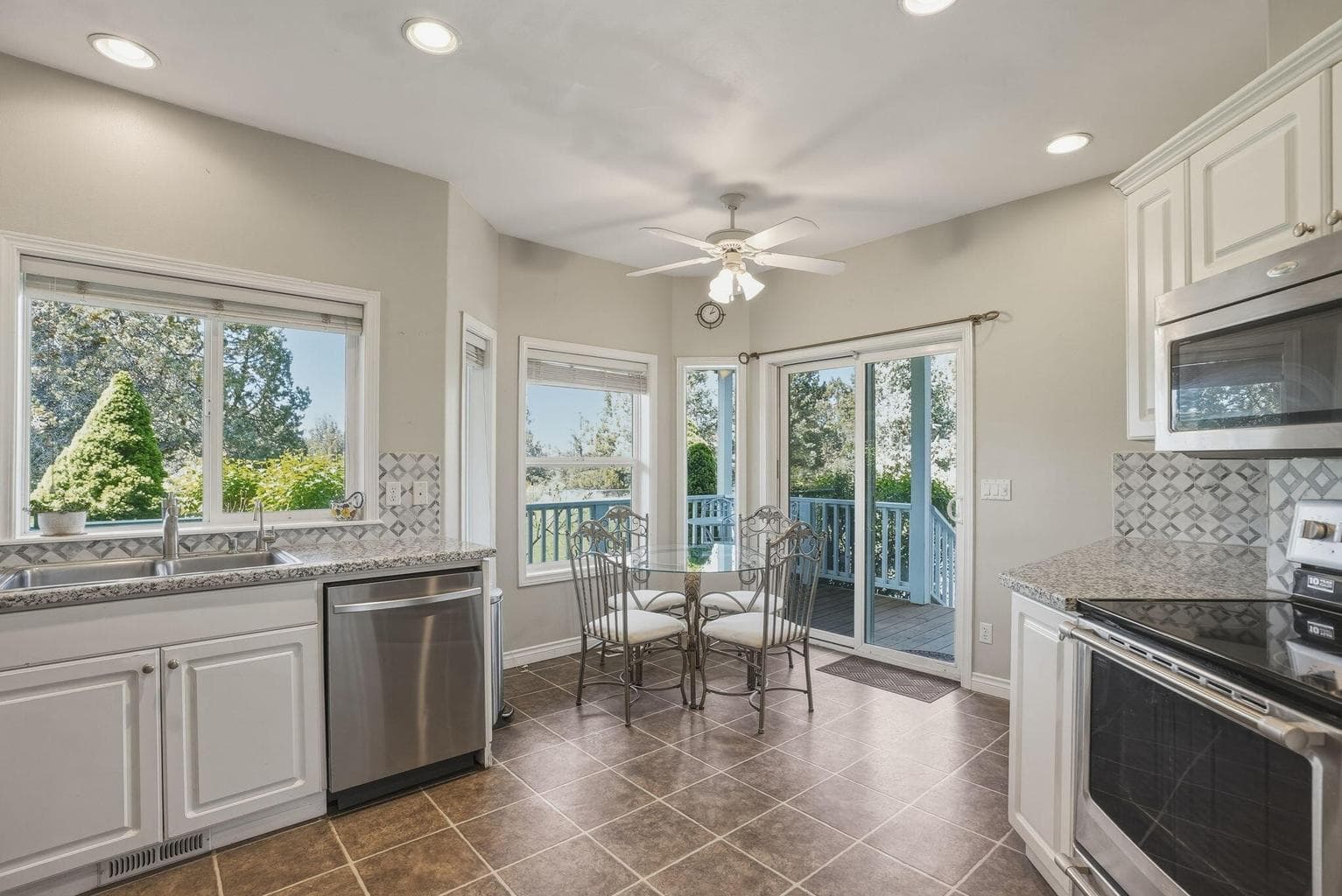 Eating area in kitchen with sliding glass door to covered deck