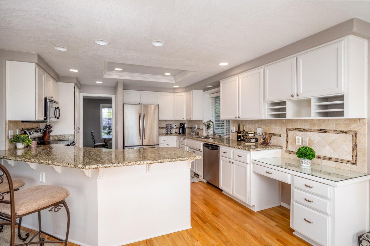 Kitchen with granite counters and tile backsplash