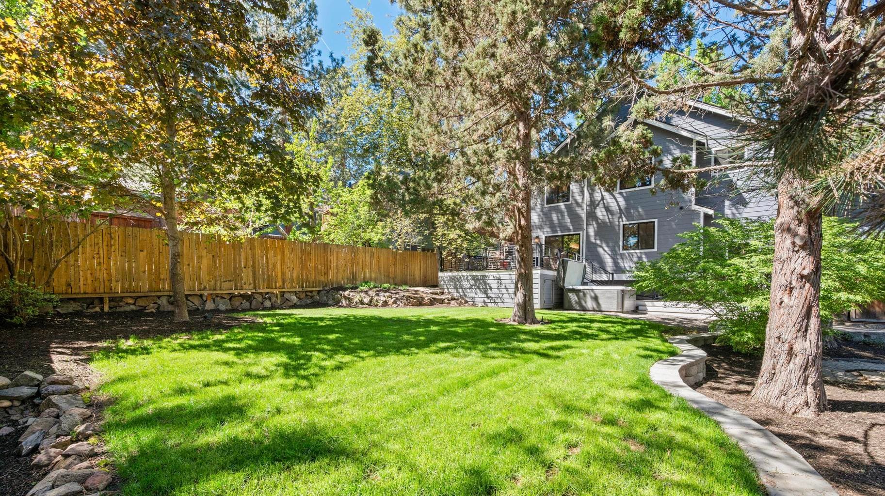Fully-fenced and professionally landscaped with multiple outdoor spaces to enjoy year round.