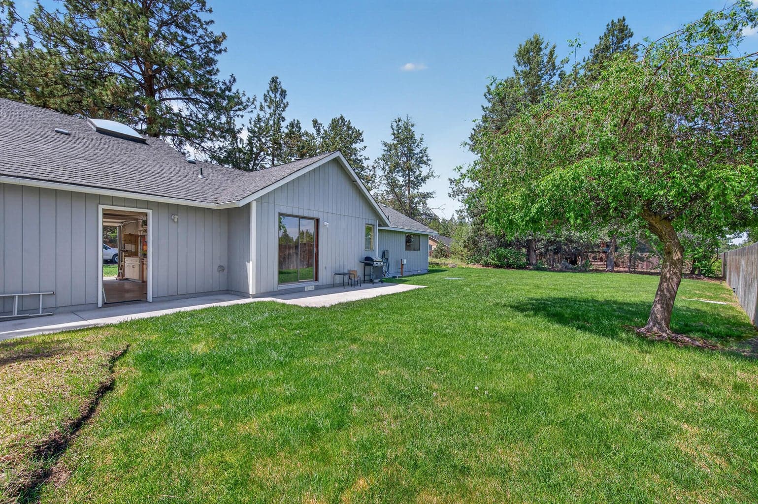 Fully fenced back yard with a shed