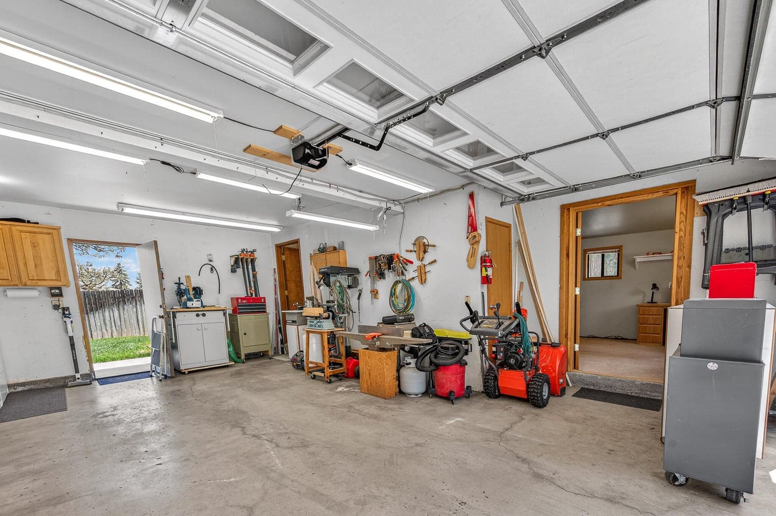 Garage with access to the back yard. The door to the right could be an office, home based business, and has a separate door to the exterior- perhaps ADU potential?