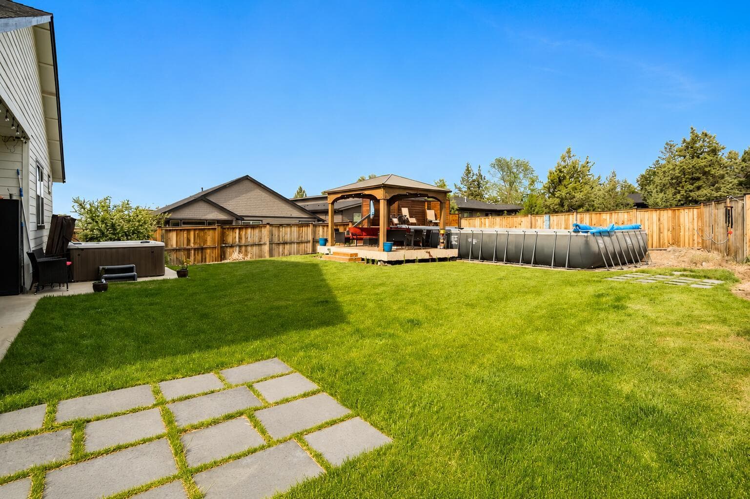 Saltwater pool with solar cover and adjacent gazebo