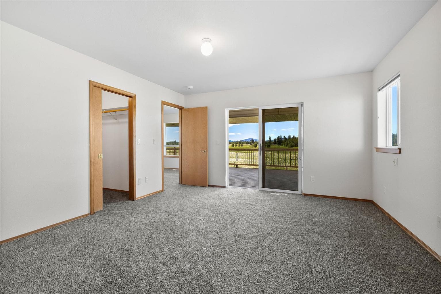 Primary has a walk-in closet and opens to the back deck