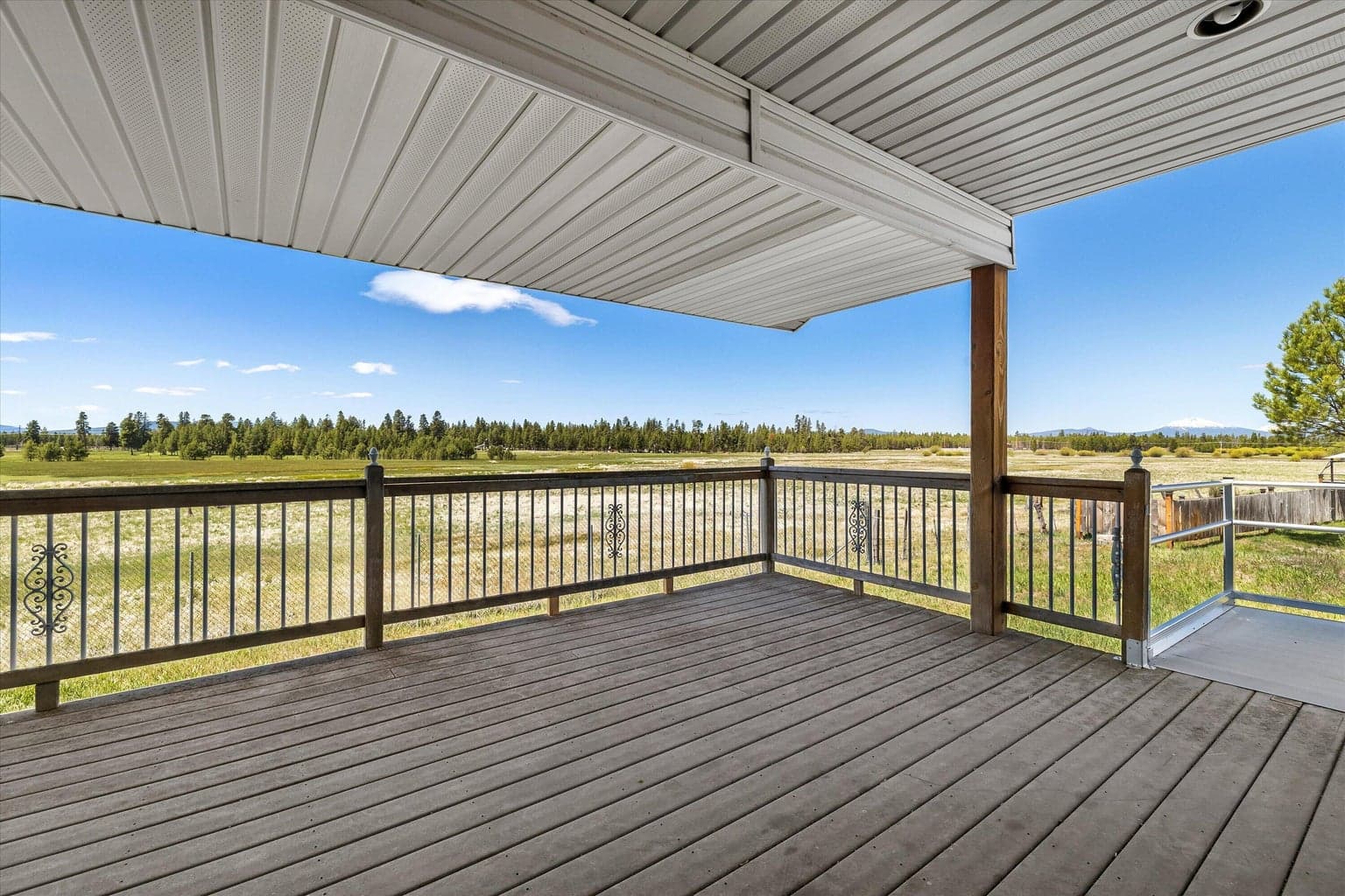 covered deck that looks out at the mountains and wetlands